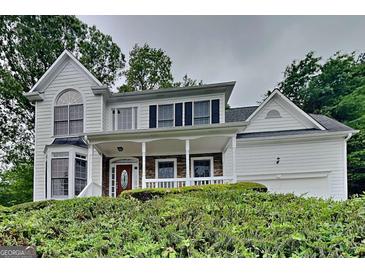 Charming two-story home with a covered front porch and stone accents at 2001 Fairbrook Ln, Woodstock, GA 30189