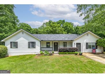 Charming single-story home with white siding, black shutters, and a well-manicured front lawn at 40 Salem Ct, Mcdonough, GA 30252