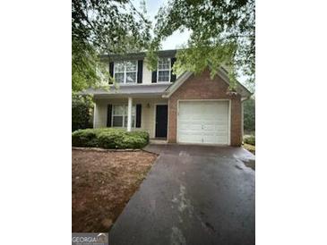 Charming two-story home with neutral siding, brick accents, and a two-car garage at 4752 Browns Mill Ferry, Lithonia, GA 30038