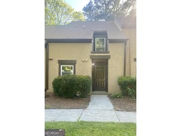 Inviting townhome exterior features a well-manicured front yard and classic architectural details at 103 Tiburon Ct, Stonecrest, GA 30038