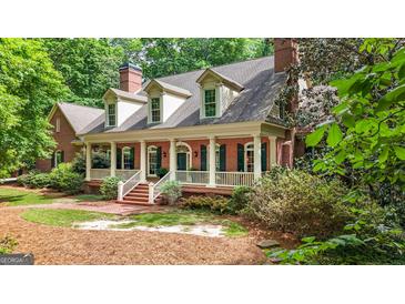 Charming brick home with a welcoming front porch and manicured landscaping at 9274 Betony Wood Trl, Jonesboro, GA 30236