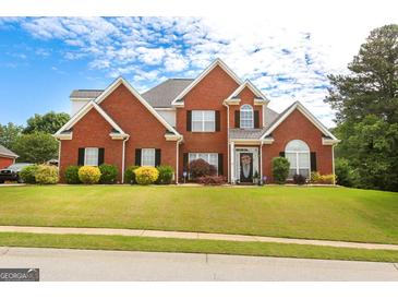 Beautiful two-story brick home featuring a well-manicured lawn and traditional architectural details at 208 Summer Chase, Carrollton, GA 30116