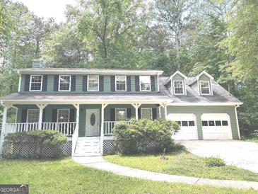 Charming two-story home with an inviting front porch and attached two-car garage at 305 Glenloch Ln, Stockbridge, GA 30281