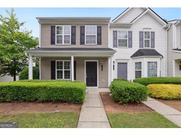 Charming townhome featuring a welcoming porch, well-maintained landscaping, and a classic, inviting facade at 1823 Devon Sw Dr, Atlanta, GA 30311