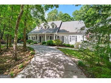 Charming home featuring a covered front porch, dormer windows, and a circular driveway at 2058 Sewanee Ct, Villa Rica, GA 30180
