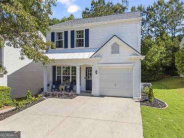 Charming two-story home with a well-manicured lawn and a spacious driveway on a sunny day at 11255 Wittenridge Dr, Alpharetta, GA 30022