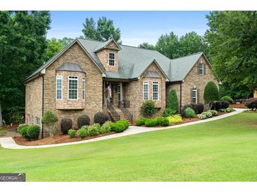 Charming single-Gathering home with brick and stone exterior, manicured lawn, and inviting entrance at 124 Belford Way, Locust Grove, GA 30248
