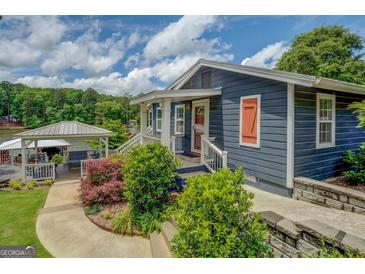 Charming home with a covered outdoor seating area and attractive landscaping at 22 Waters Bridge Cir, Covington, GA 30014
