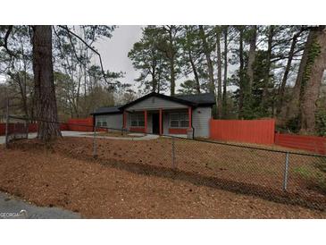 Charming single-story home with grey siding, red accents, and a well-maintained front yard at 3479 Thompson Nw Dr, Atlanta, GA 30331
