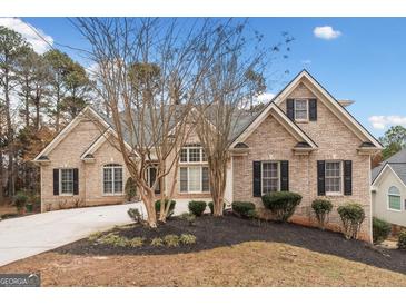Traditional brick home boasts manicured landscaping and a well-maintained lawn at 1007 Fairway Seven, Villa Rica, GA 30180
