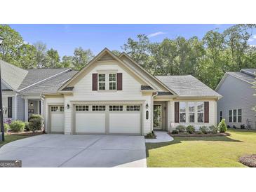 Charming single-story home with a three-car garage, tidy lawn, and manicured landscaping at 430 Silverbell Ct, Peachtree City, GA 30269
