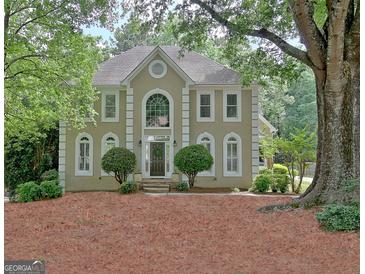 Traditional two-story home boasting well-manicured landscaping and classic architectural details at 112 Windalier Rdg, Peachtree City, GA 30269