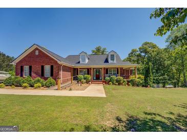 Charming single-story brick home with a well-manicured lawn and inviting covered front porch at 637 Lakeview Dr, Newborn, GA 30056
