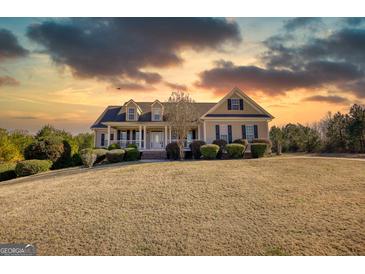 Inviting single-Gathering home with manicured lawn, lovely front porch, and warm curb appeal at 4180 Mount Paran Dr, Social Circle, GA 30025