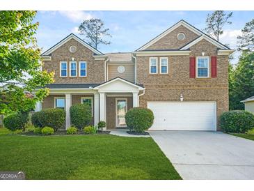 Charming brick home featuring a well-manicured lawn, two-car garage and inviting front porch at 6533 Waterford Sw St, Atlanta, GA 30331