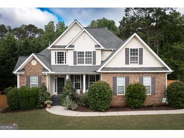 Charming two-story home with a brick facade, gray shutters, manicured landscaping, and a welcoming front porch at 150 Murphy Creek Ln, Fayetteville, GA 30215