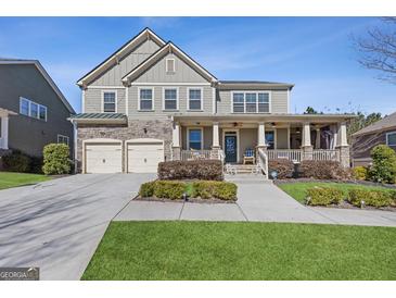 Charming two-story home with a welcoming front porch and manicured lawn at 3213 Blackley Old Rd, Douglasville, GA 30135