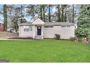 Charming single-story home with a well-manicured lawn and classic brick exterior at 3317 Renault Se Rd, Atlanta, GA 30354