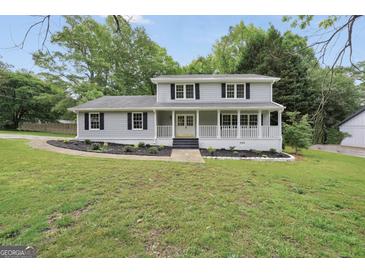 Charming two-story home with a inviting front porch and well-manicured lawn at 3440 Concord Se Cor, Conyers, GA 30013