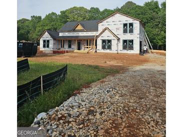 New construction home featuring black windows, covered porch, and wood details at 95 Cambridge, Covington, GA 30014