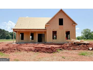 Unfinished home featuring a gable roof, window openings, and a partially covered front porch at 242 Old Jackson Rd, Mcdonough, GA 30252