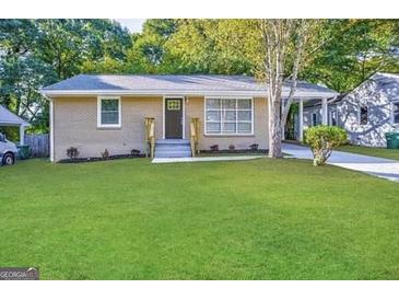 Charming single-story brick home featuring a well-manicured lawn and welcoming front entrance at 2851 Mitchell Dr, Decatur, GA 30032