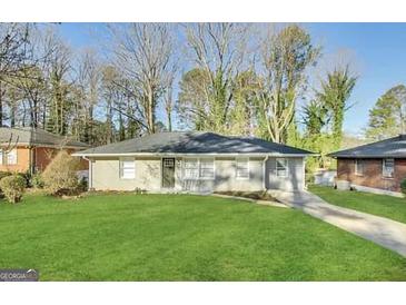 Charming one-story home with a well-maintained lawn and a paved driveway at 2215 Rosewood Rd, Decatur, GA 30032