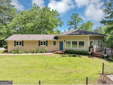 Charming ranch-style home with a well-maintained lawn, mature trees, and inviting curb appeal at 4820 Yeager Rd, Douglasville, GA 30135