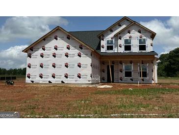 New construction home featuring architectural details awaiting finishing touches, including large windows at 1936 King Mill Rd, Mcdonough, GA 30252
