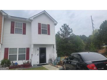 Charming townhouse with a cozy front porch and well-maintained exterior at 6880 Mountain Cir, Riverdale, GA 30274