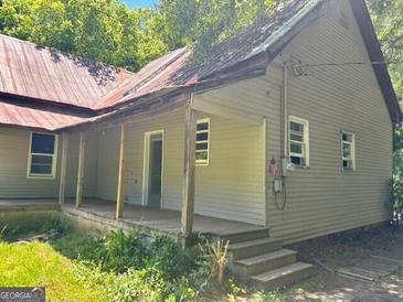 A quaint home with a classic design and a welcoming porch, perfect for relaxing outdoors at 585 Huddleston Rd, Fayetteville, GA 30214
