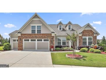 Charming home featuring a well-maintained lawn, a two-car garage, and eye-catching brick and siding accents at 500 Cottonwood Cir, Peachtree City, GA 30269