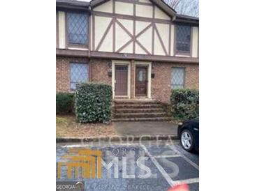Charming exterior of a multi-Gathering building with brick facade and Tudor-style accents at 3189 Abbeywood Dr, Decatur, GA 30034