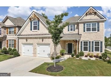 Charming brick two-story home with a well-manicured lawn, two-car garage and attractive architectural details at 3970 Lagrone St, Powder Springs, GA 30127