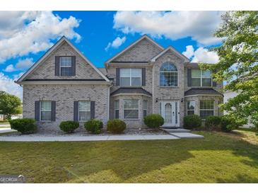 Beautiful two-story home featuring a brick facade, well-manicured lawn, and a welcoming front entrance at 1441 Saint George Pl, Conyers, GA 30012