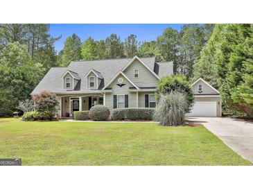 Charming home with a well-manicured lawn, dormer windows, and a welcoming facade exudes curb appeal at 465 Crabapple Rd, Fayetteville, GA 30215