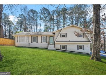 Charming two-story home with a well-manicured lawn and mature trees offers excellent curb appeal at 2511 Due West Nw Cir, Kennesaw, GA 30152