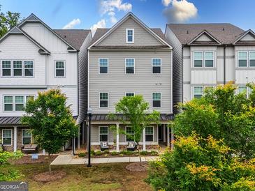 Charming townhome with gray siding, a covered front porch, and manicured landscaping at 2108 Remy Ct, Kennesaw, GA 30144