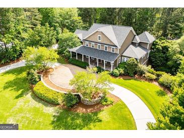 Expansive home featuring a front porch, beautiful landscaping and a circular driveway at 115 Champion Dr, Carrollton, GA 30116