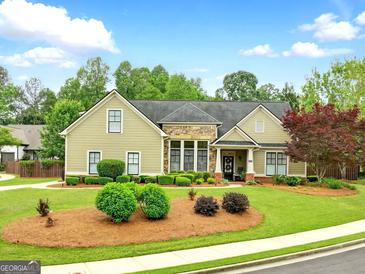 Charming one-story home features a well-manicured lawn and inviting landscaping at 3174 Piney Woods Cir, Buford, GA 30519