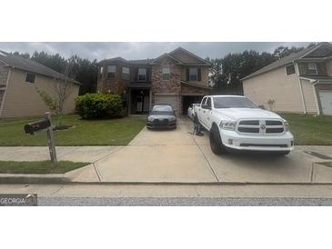 Two-story home with brick facade, manicured lawn, and ample parking space at 7644 Wrotham Cir, South Fulton, GA 30349