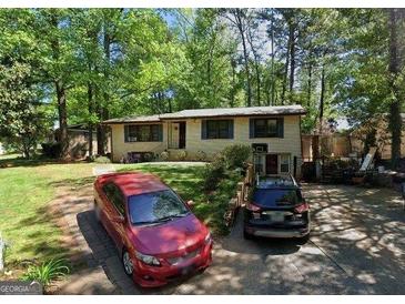 Charming single-story home with a well-maintained lawn and driveway at 1071 Ponderosa Park Dr, Forest Park, GA 30297