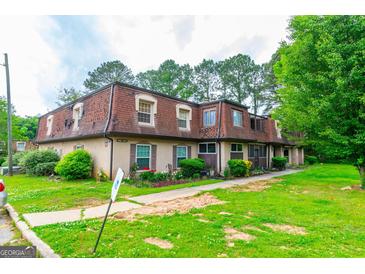 Charming townhomes with red roofing and well-maintained green lawn at 2986 Parc Lorraine, Lithonia, GA 30038