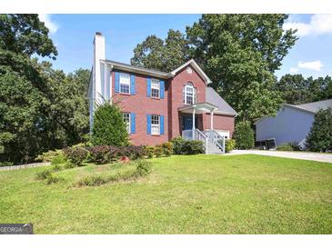 Charming two-story brick home with blue shutters and well-manicured lawn, offering classic curb appeal at 3161 Pagoda Trce, Lawrenceville, GA 30043