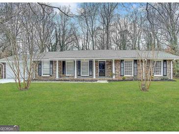 Charming brick home with a well-manicured front yard and classic design elements at 4313 Executive Dr, Stone Mountain, GA 30083