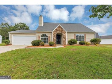 Charming single-story home features stone accents, neutral siding, attached garage, and a well-maintained lawn at 5669 Blackberry Row, Ellenwood, GA 30294