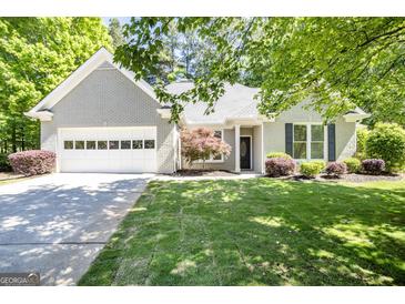 Charming home featuring a well-maintained front yard and an attached garage at 1155 Graystone Xing, Alpharetta, GA 30005