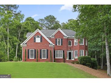 Classic brick home with a manicured lawn and mature trees at 240 Longmead Dr, Fayetteville, GA 30215