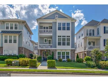 Charming three-story home with manicured lawn, lush bushes, and a welcoming facade at 405 Bandon Way, Peachtree City, GA 30269