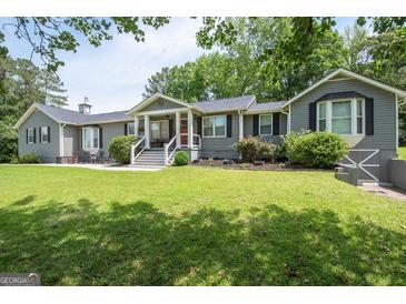 Charming ranch-style home with a well-maintained lawn and inviting entrance at 105 Greenfield Cir, Fayetteville, GA 30215
